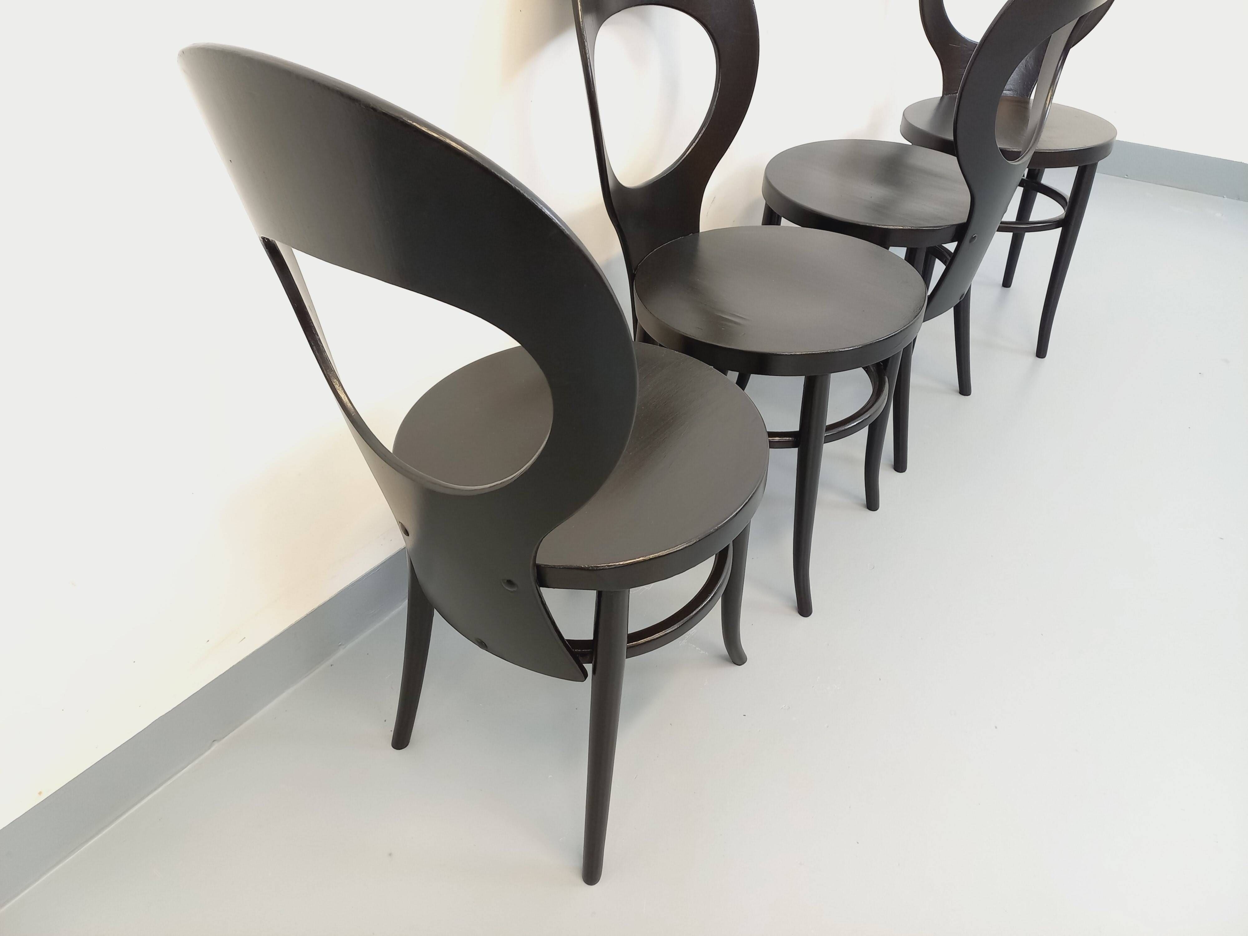 Set of 4 vintage Mouette chairs by Baumann in black wood from the 1960s.