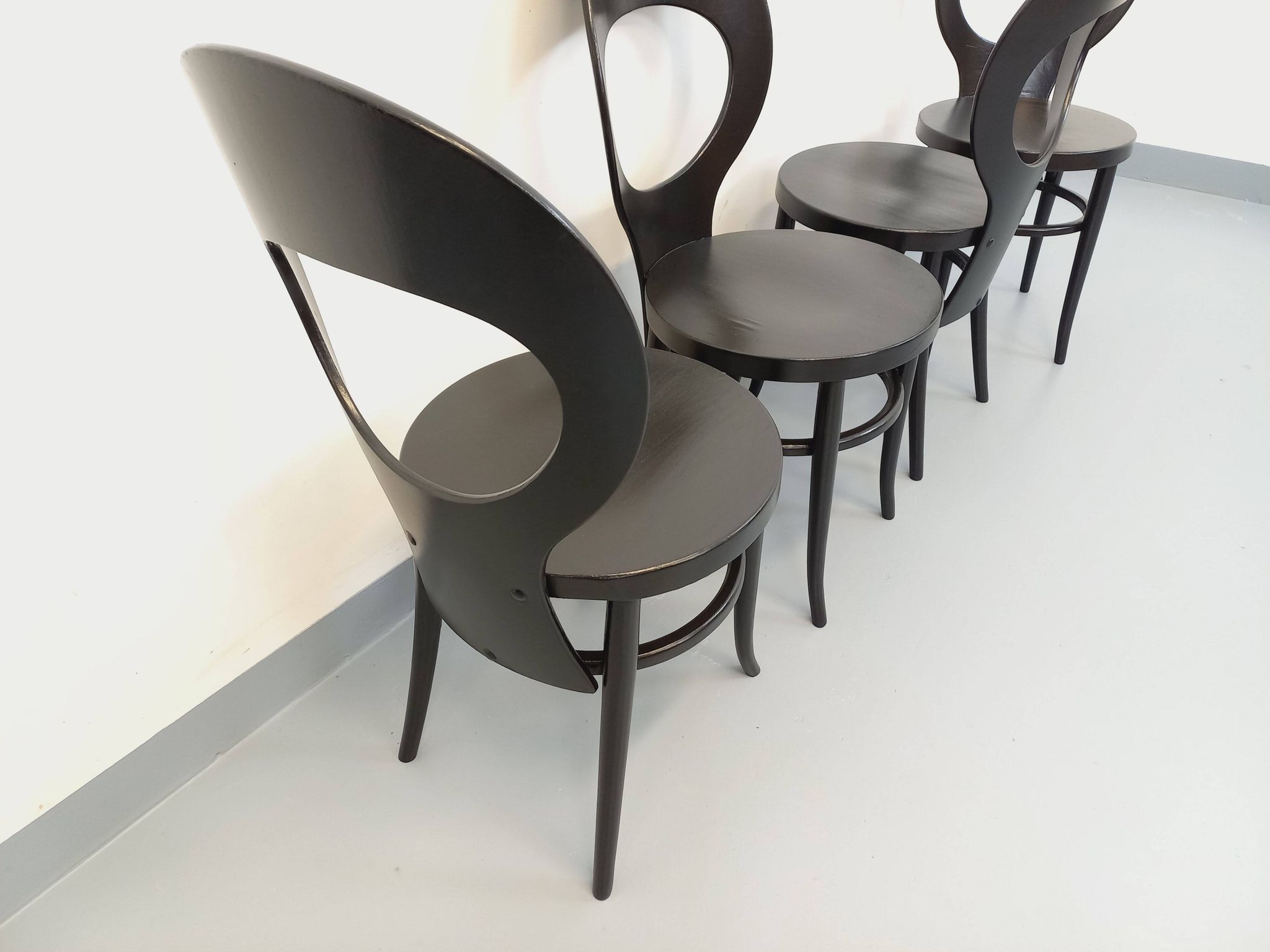 Set of 4 vintage Mouette chairs by Baumann in black wood from the 1960s.