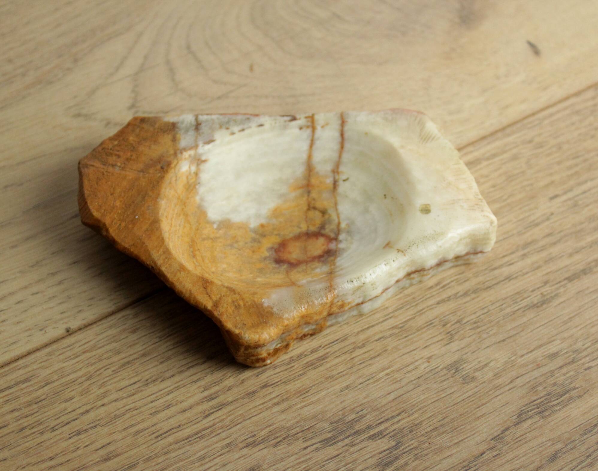 Empty pocket in orange and white marble ashtray