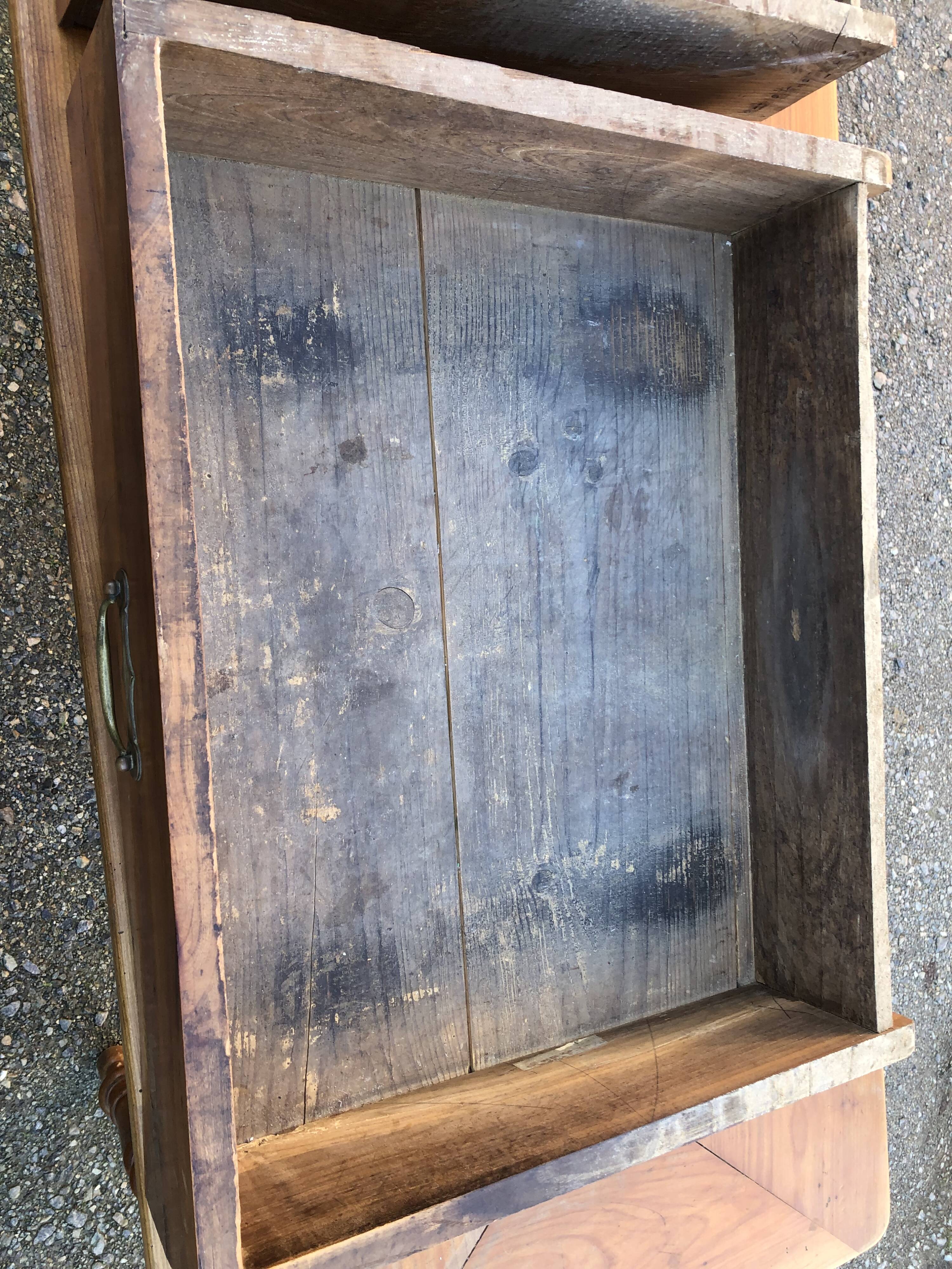 Antique cherry farmhouse table with turned legs and 2 drawers.
