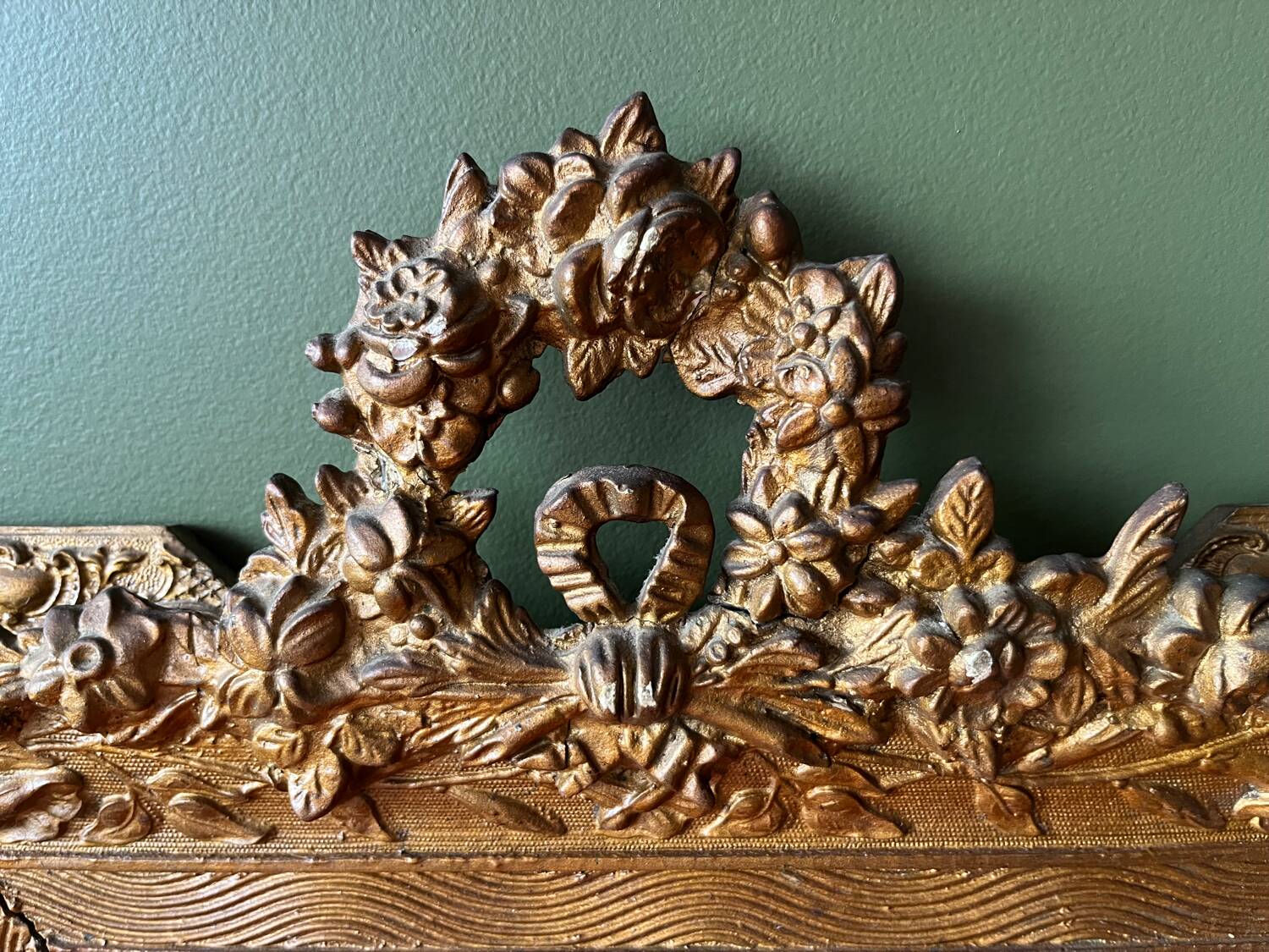 Golden trumeau mirror for fireplace, late 19th century, with sculpted pediment.