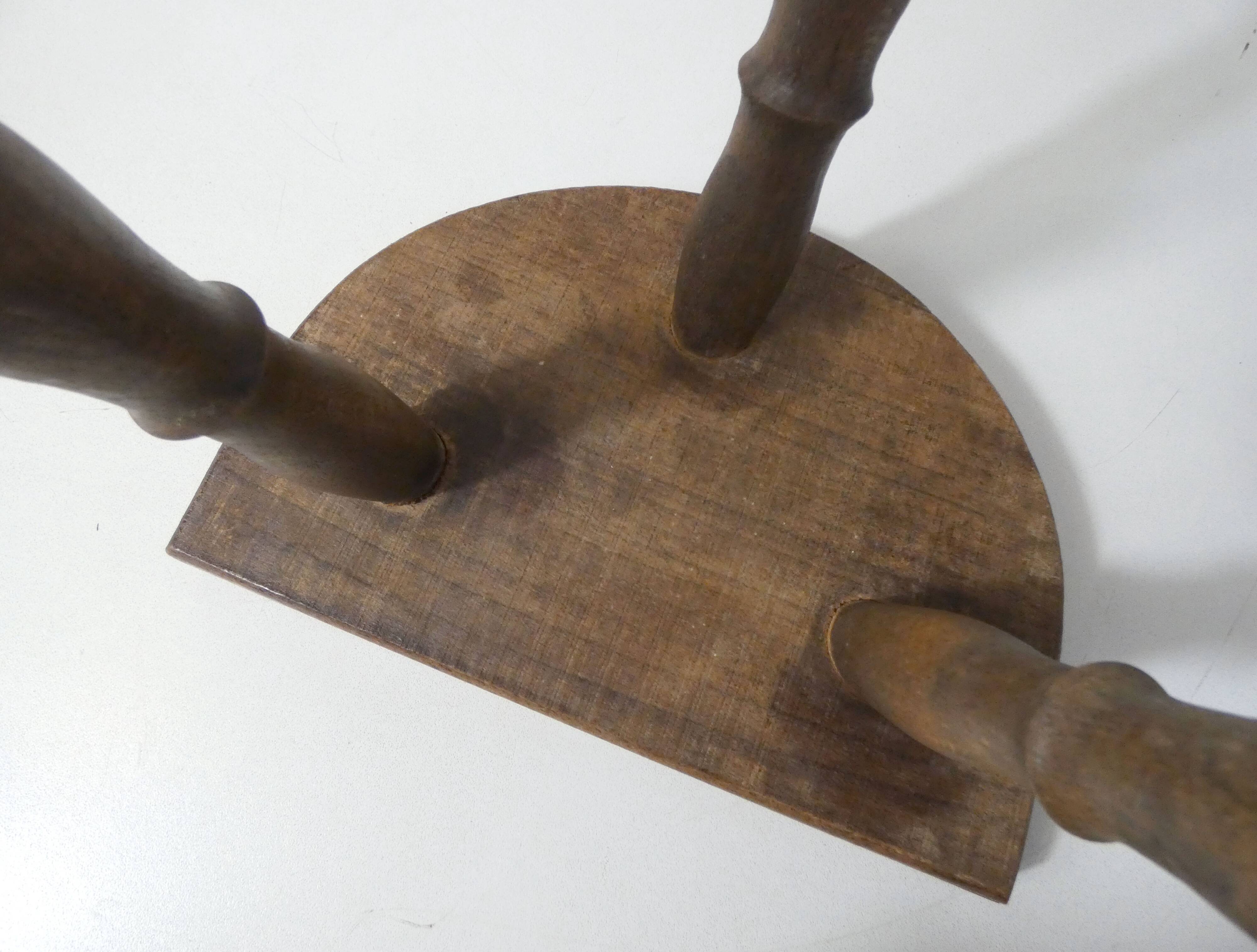 Old milking bench tripod stool in solid wood