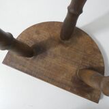 Old milking bench tripod stool in solid wood