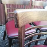 Set of 8 bistro chairs in vintage red wood and leatherette.