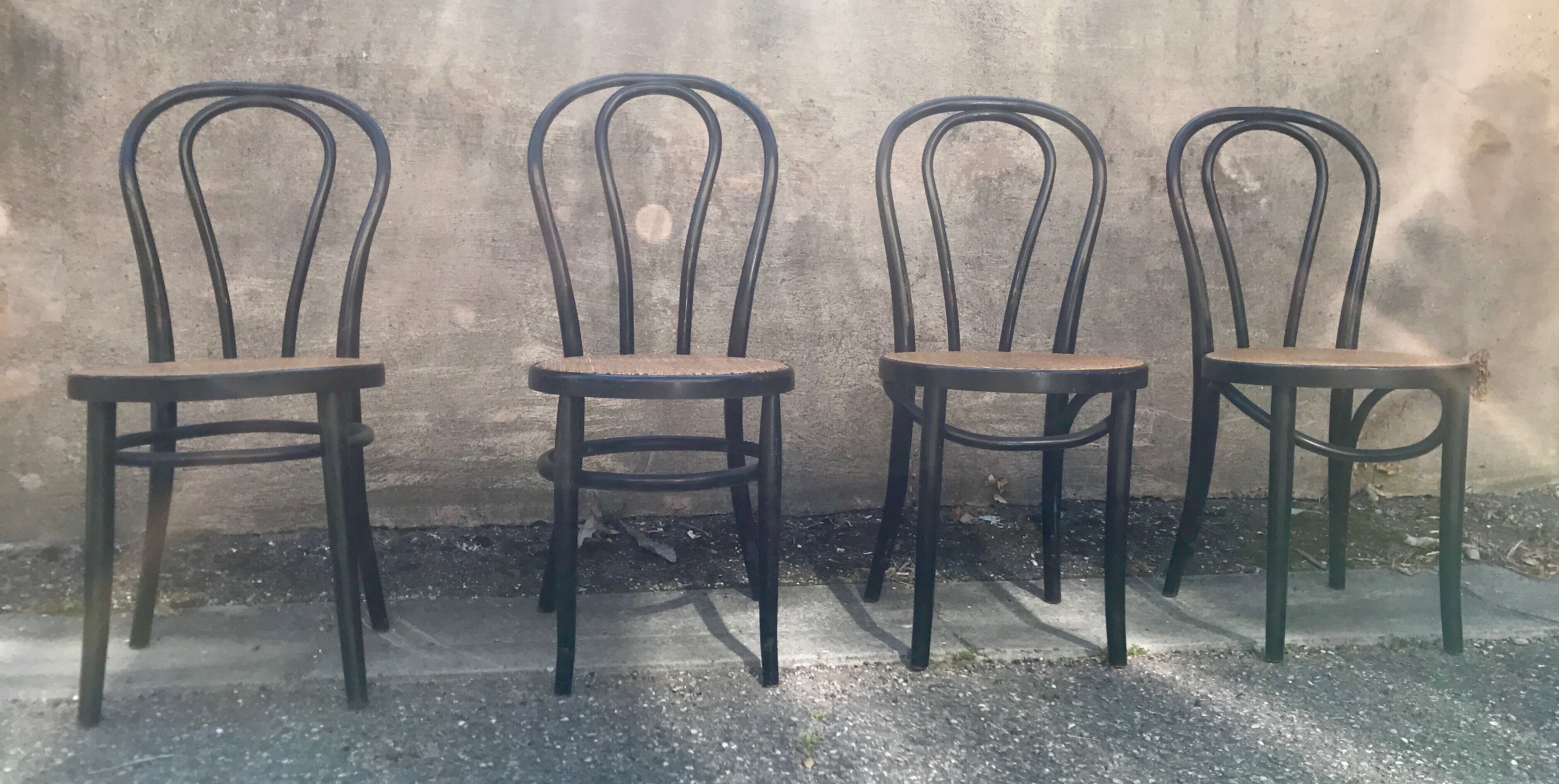 Two pairs of black 50s chairs - number 18 - cannée