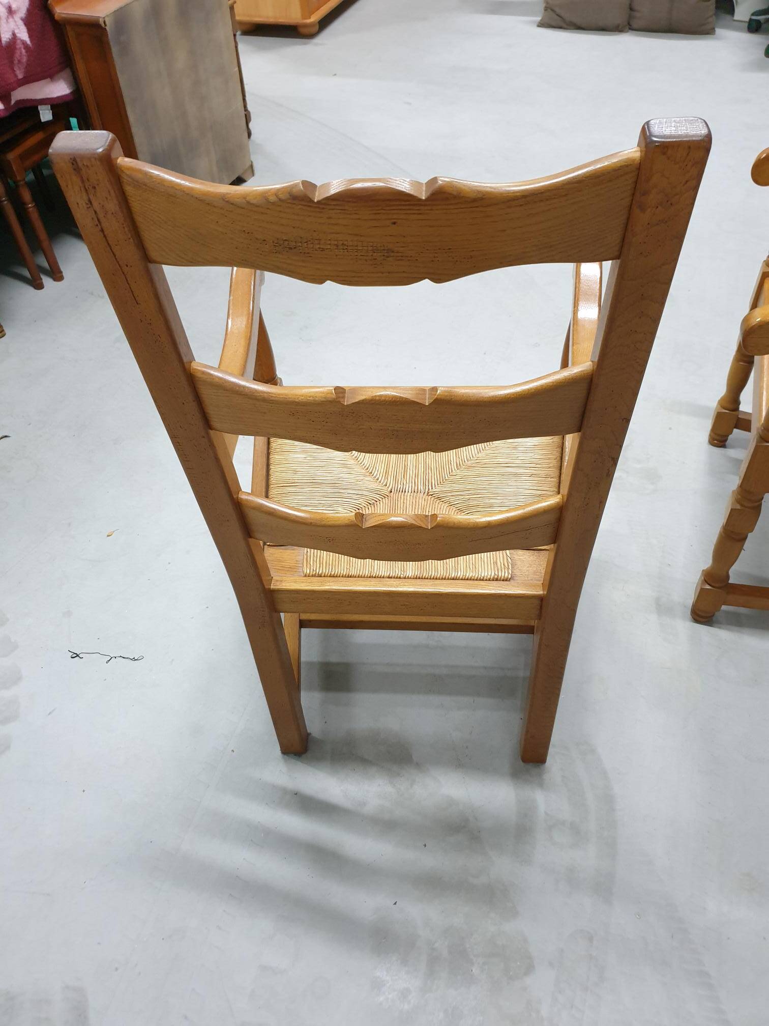 Two oak armchairs with straw seats