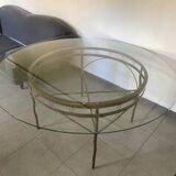 Round table with glass top and ornate metal base