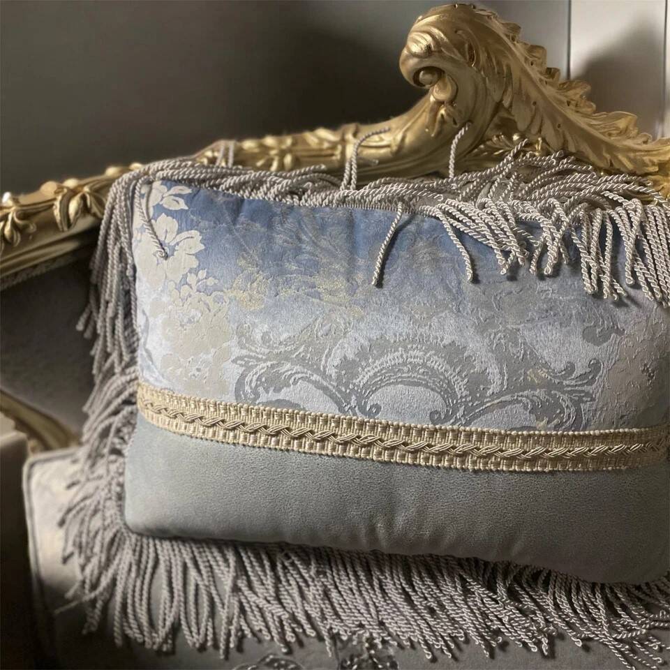 A soft light blue and silver tufted beech wood sofa in Louis style.