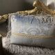 A soft light blue and silver tufted beech wood sofa in Louis style.