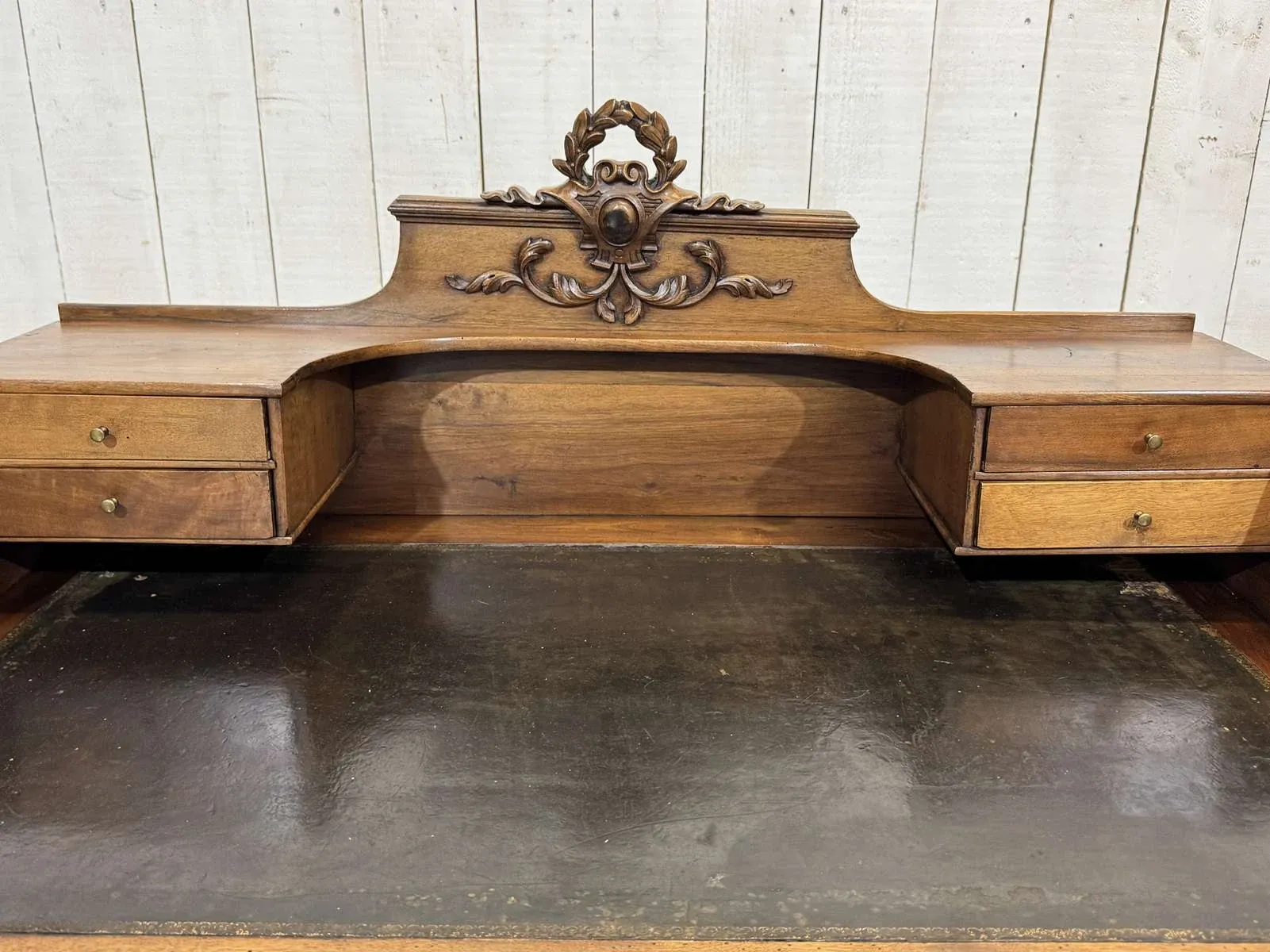 Louis XVI style desk from the late 19th century in walnut with a leather top.