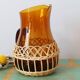 Amber glass decanter dressed in wicker, vintage