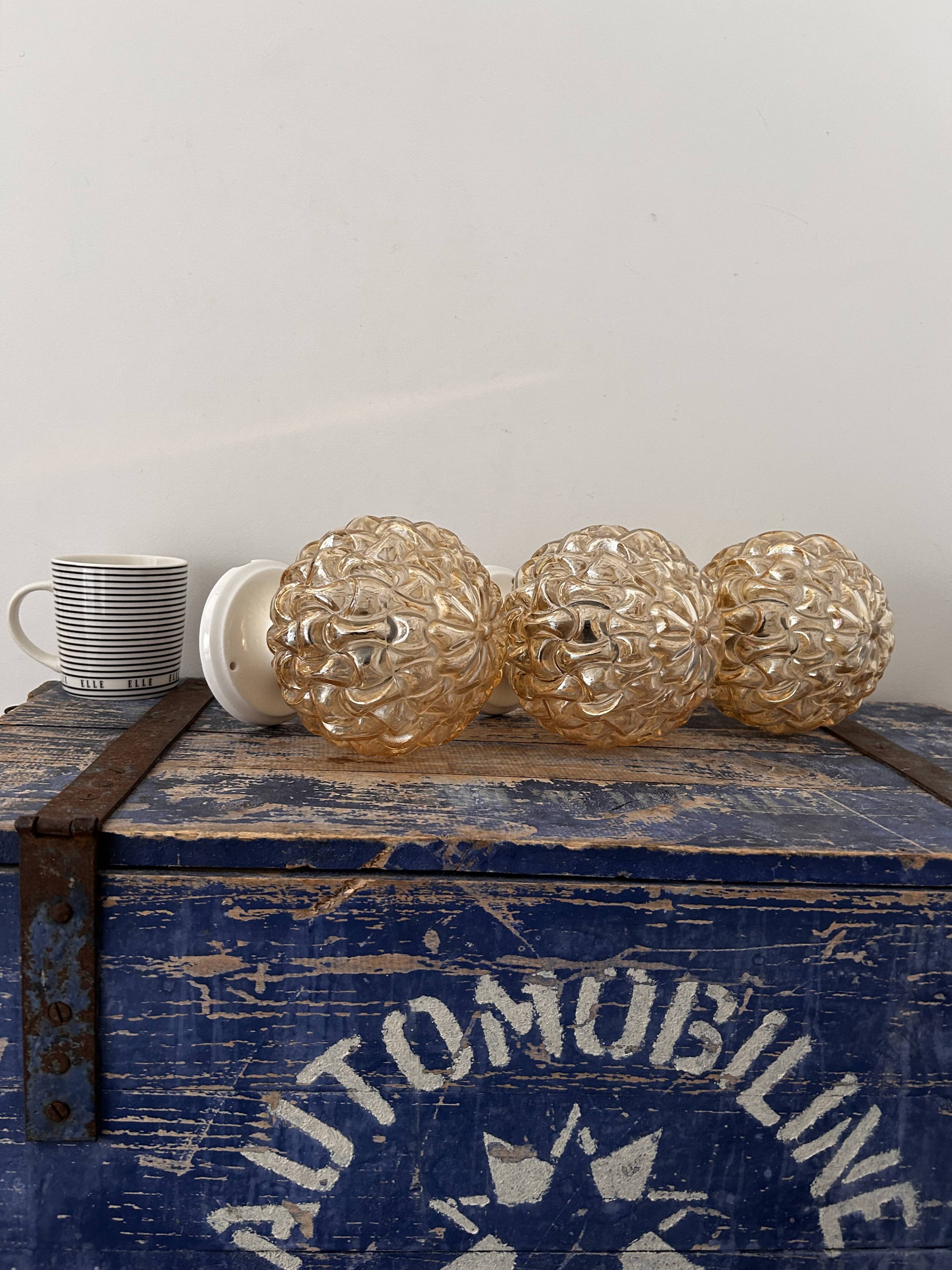 Trio of golden globe wall or ceiling lights