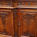 Antique rococo sideboard with integrated clock.