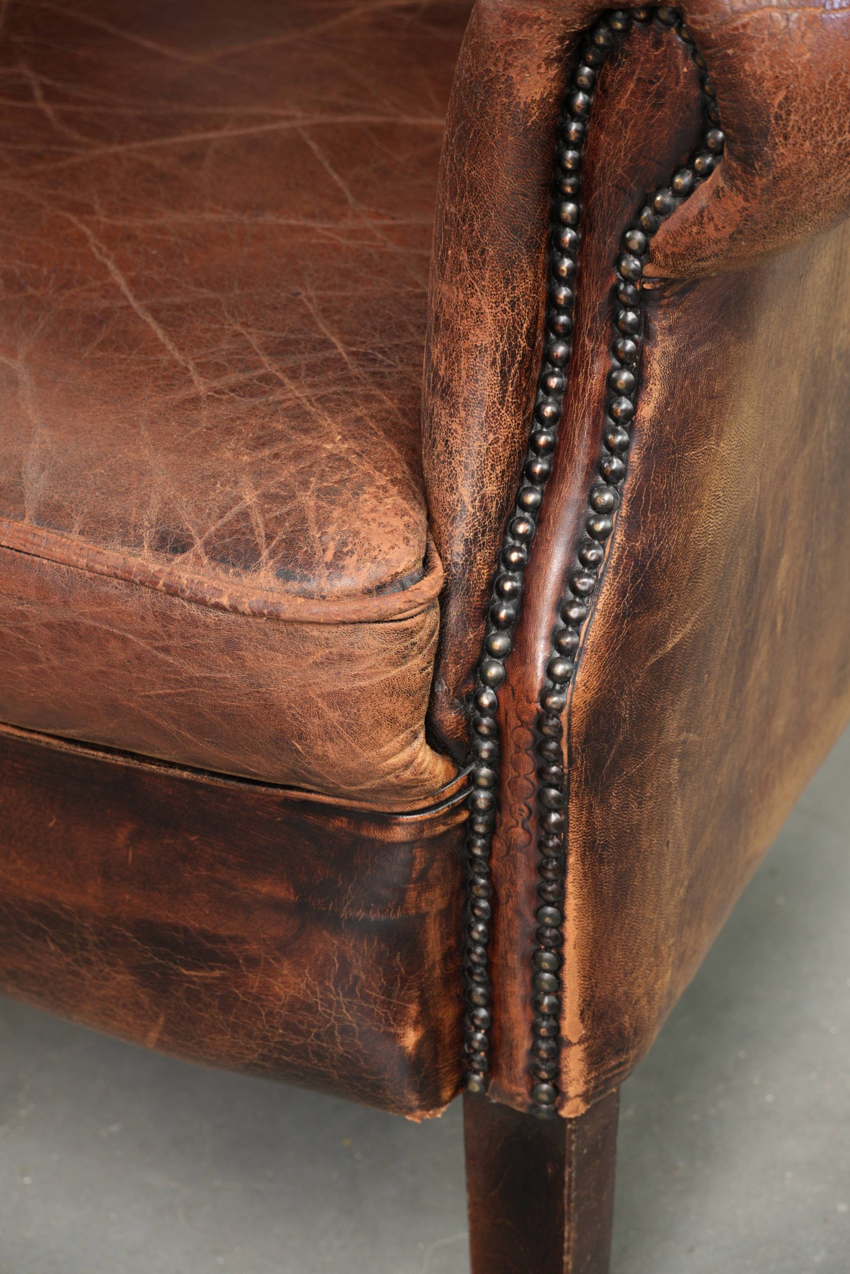 Vintage sheepskin wingback armchair in a deep brown colour finished