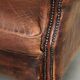 Vintage sheepskin wingback armchair in a deep brown colour finished