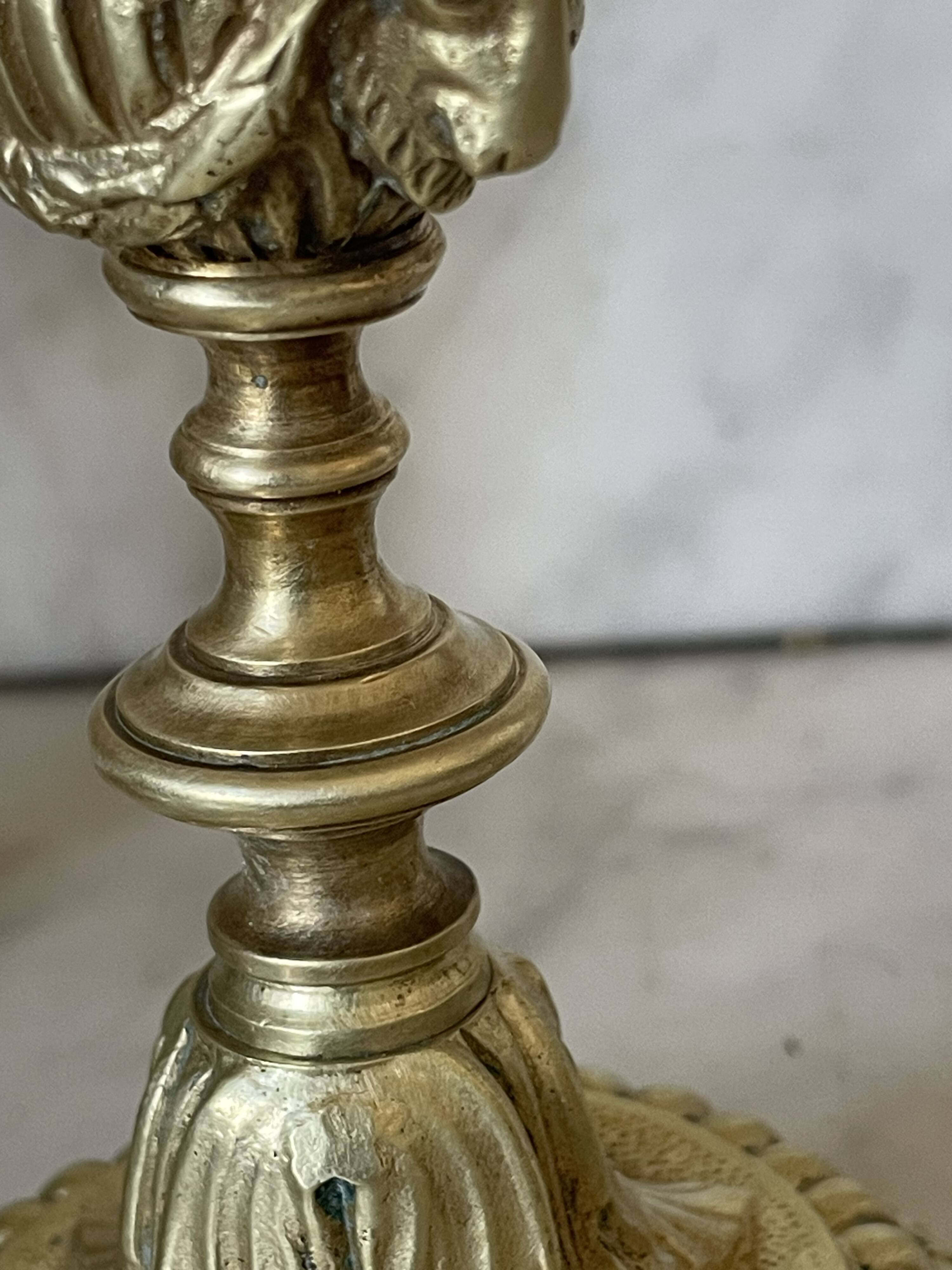 Pair of gilt bronze ram's head candlesticks, Louis XVI style, 19th century.