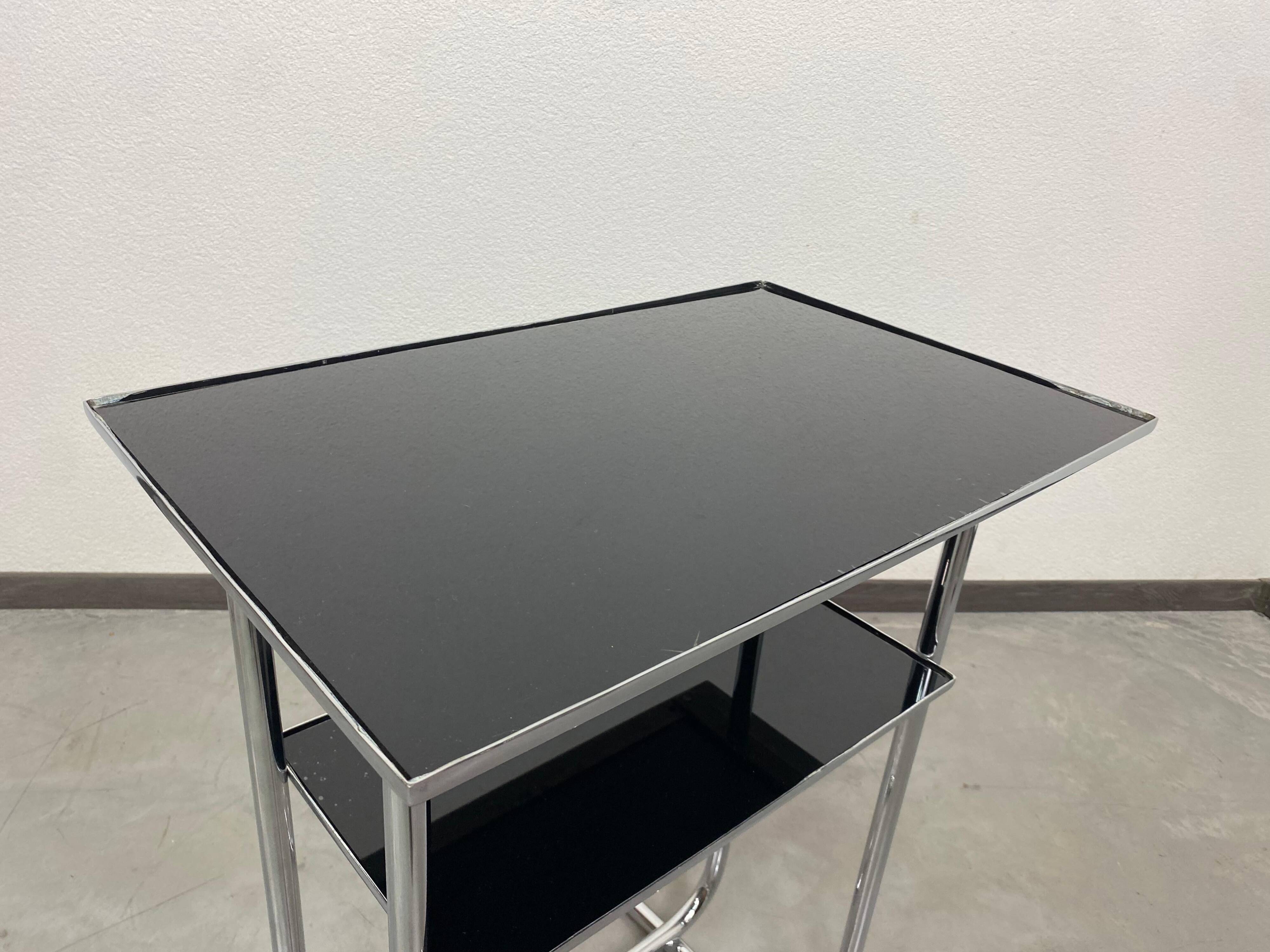 Bauhaus side table with a black glass top