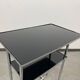 Bauhaus side table with a black glass top