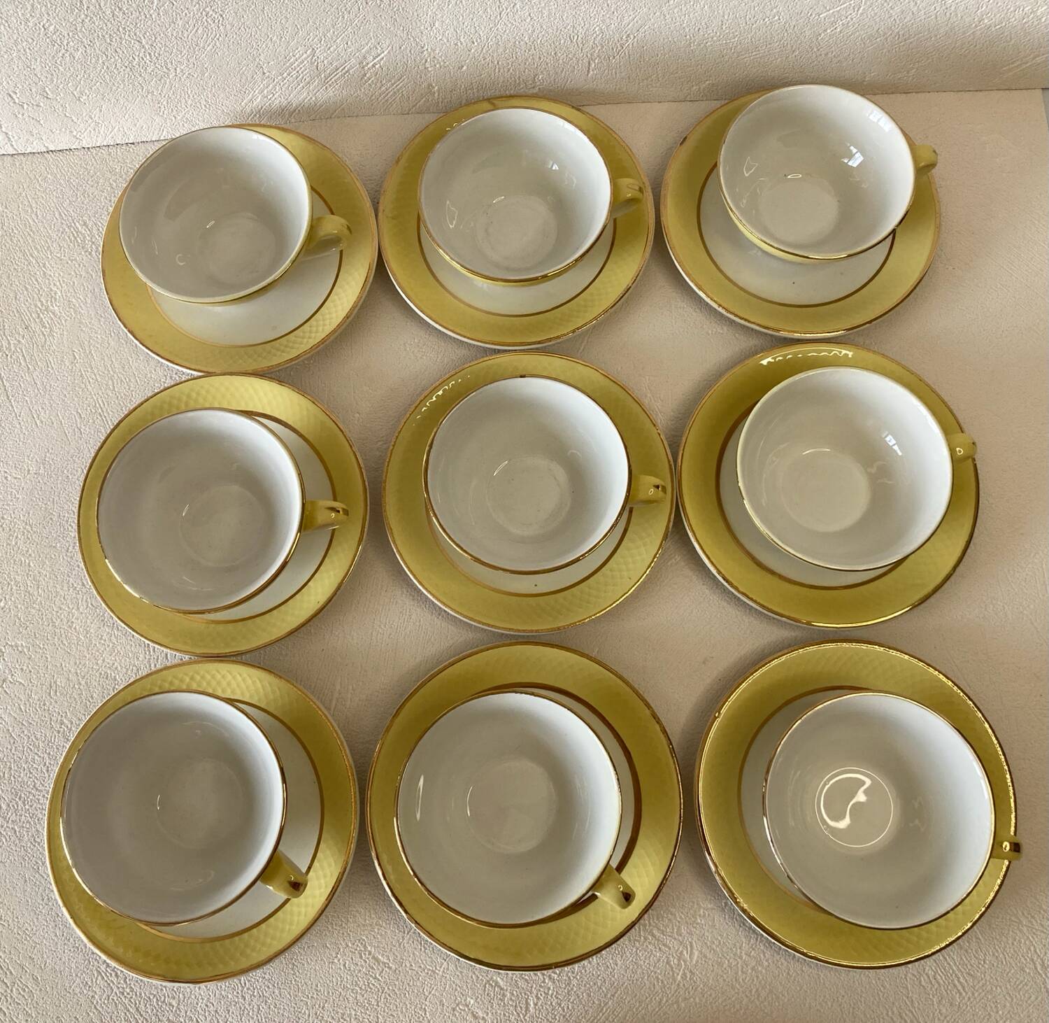 Yellow and white cups and saucers with gold trim Moulin des loups