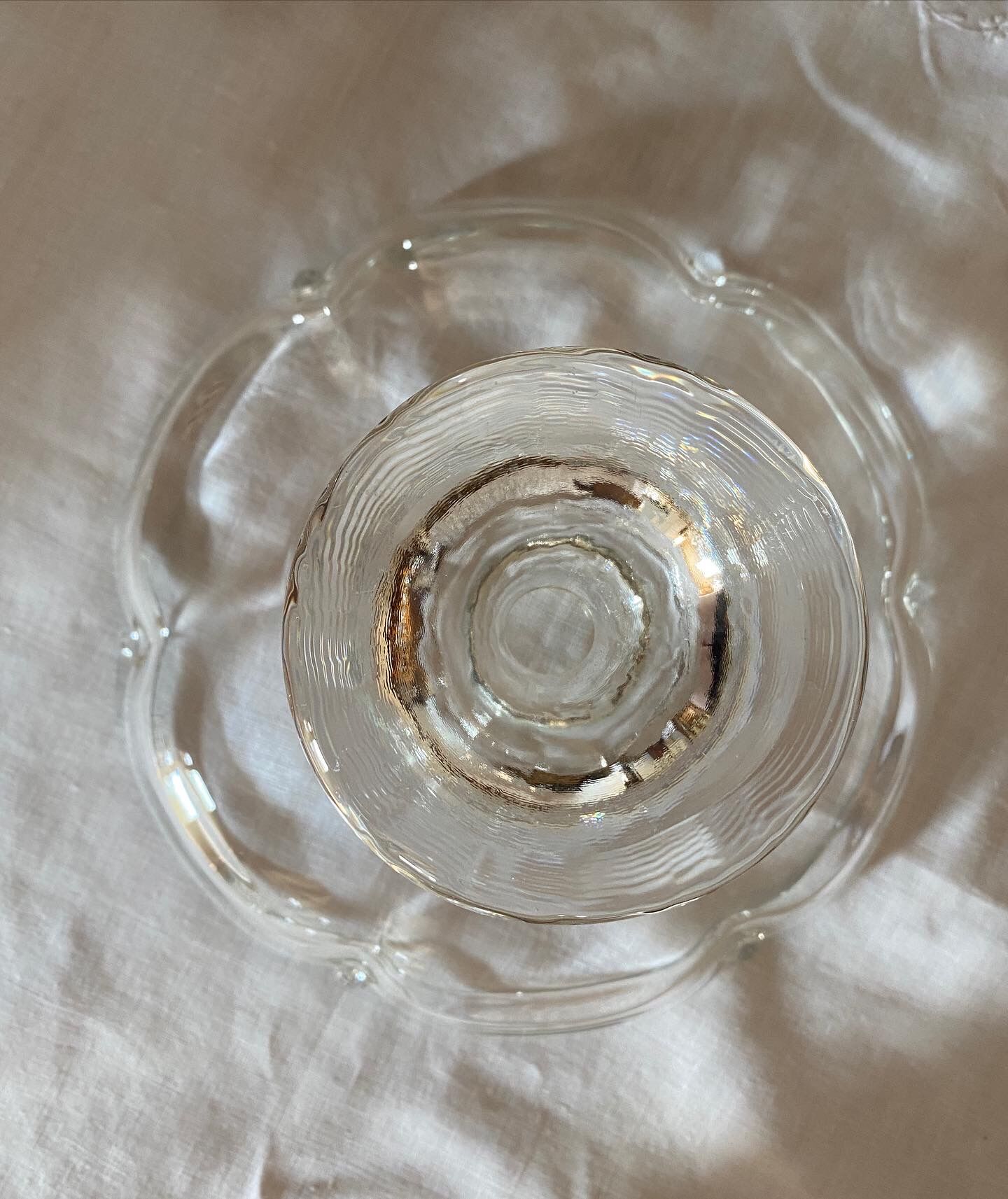 Standing molded glass cup depicting a flower