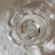 Standing molded glass cup depicting a flower