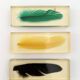 Six feather-shaped knife rests in resin inclusion.