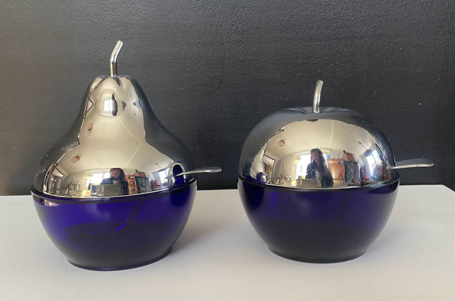 A pair of vintage cobalt glass and silver-plated sugar bowls.
