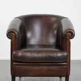 Dark brown vintage club armchair in English style made of sheepskin leather