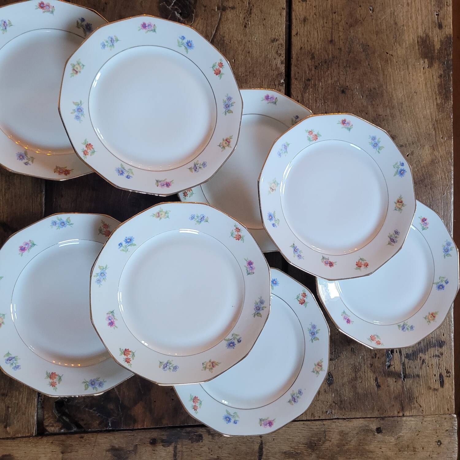 8 porcelain dessert plates with gold rim and various flowers