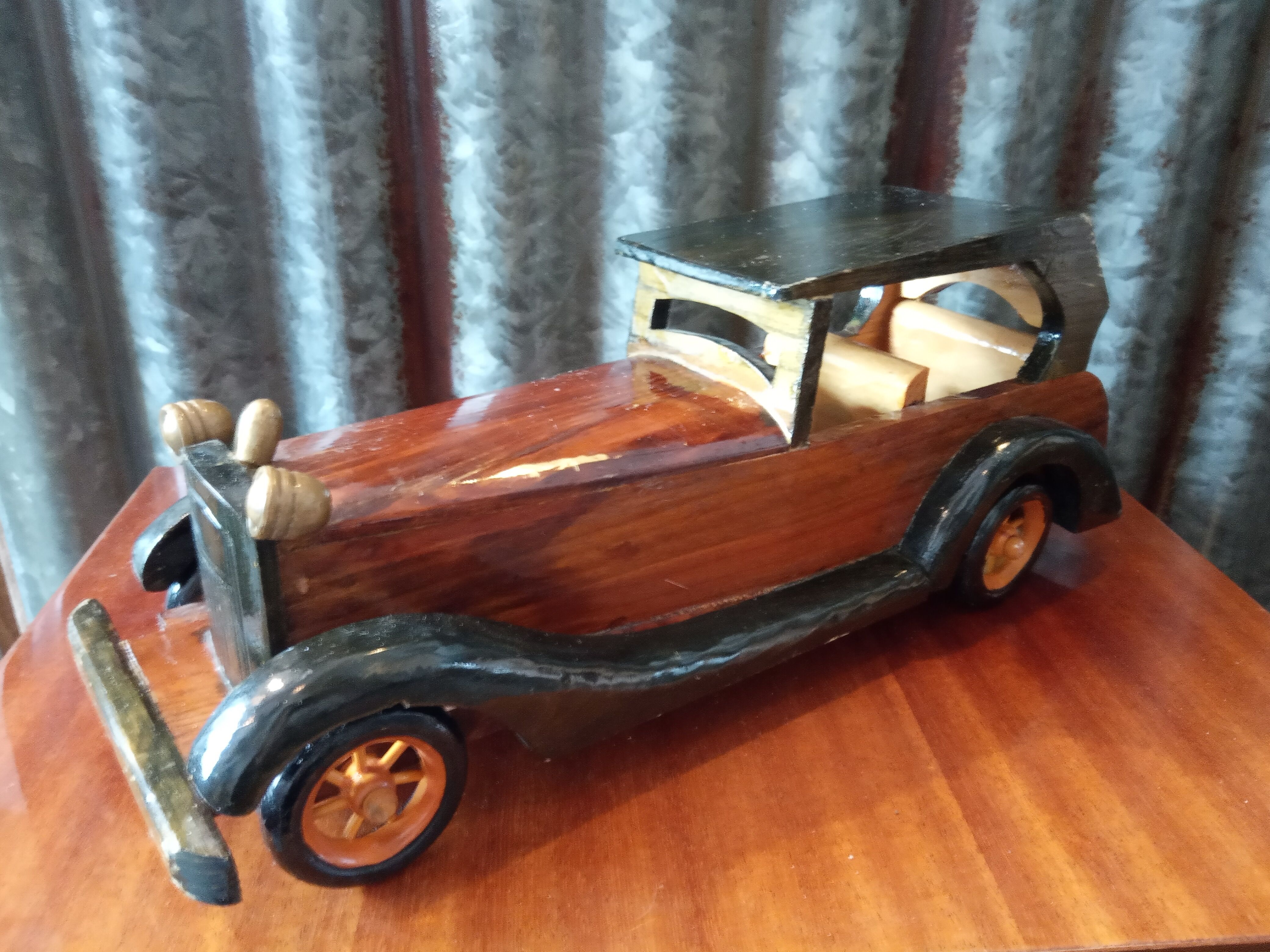 Toy car made of varnished wood