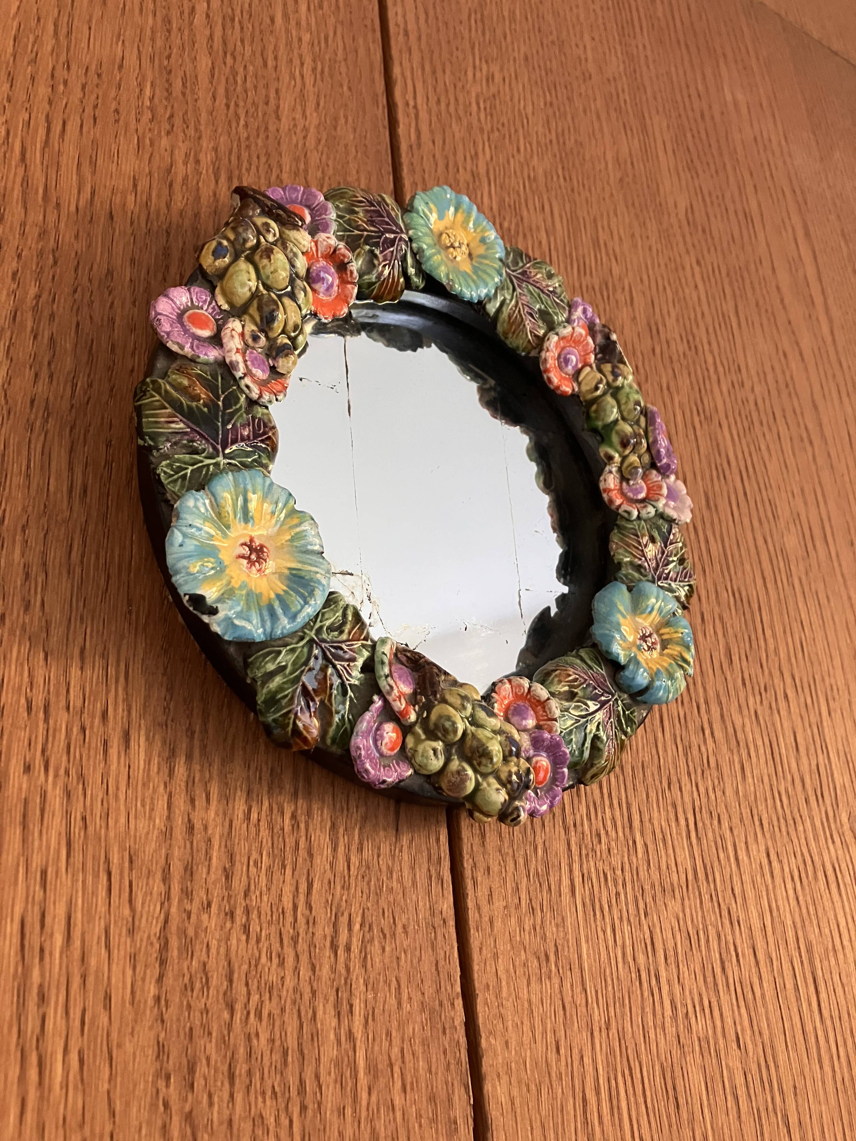 Round wall mirror in ceramic with slip-cast flowers, glazed, from the 60s/70s.