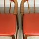 Pair of Scandinavian armchairs in teak and red faux leather – 1960s