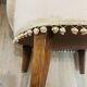 Pale pink upholstered armchair with wooden legs.