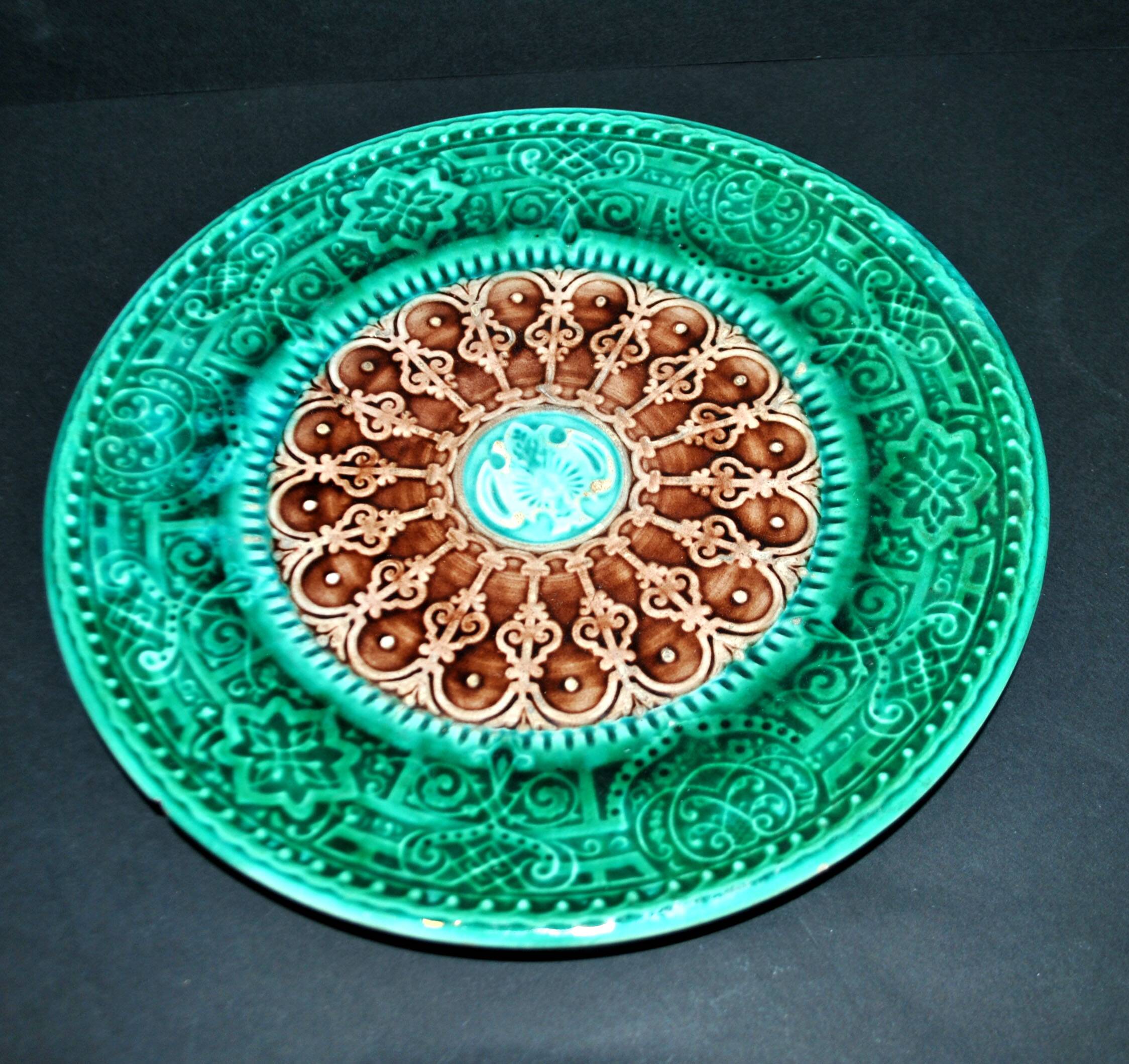 Antique plate in turquoise brown green slip with arabesque decoration