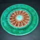 Antique plate in turquoise brown green slip with arabesque decoration