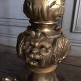 A gilded carved wooden pedestal table with a marble marquetry top