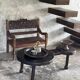 Small antique Indonesian bench in carved teak with plant and floral motifs.