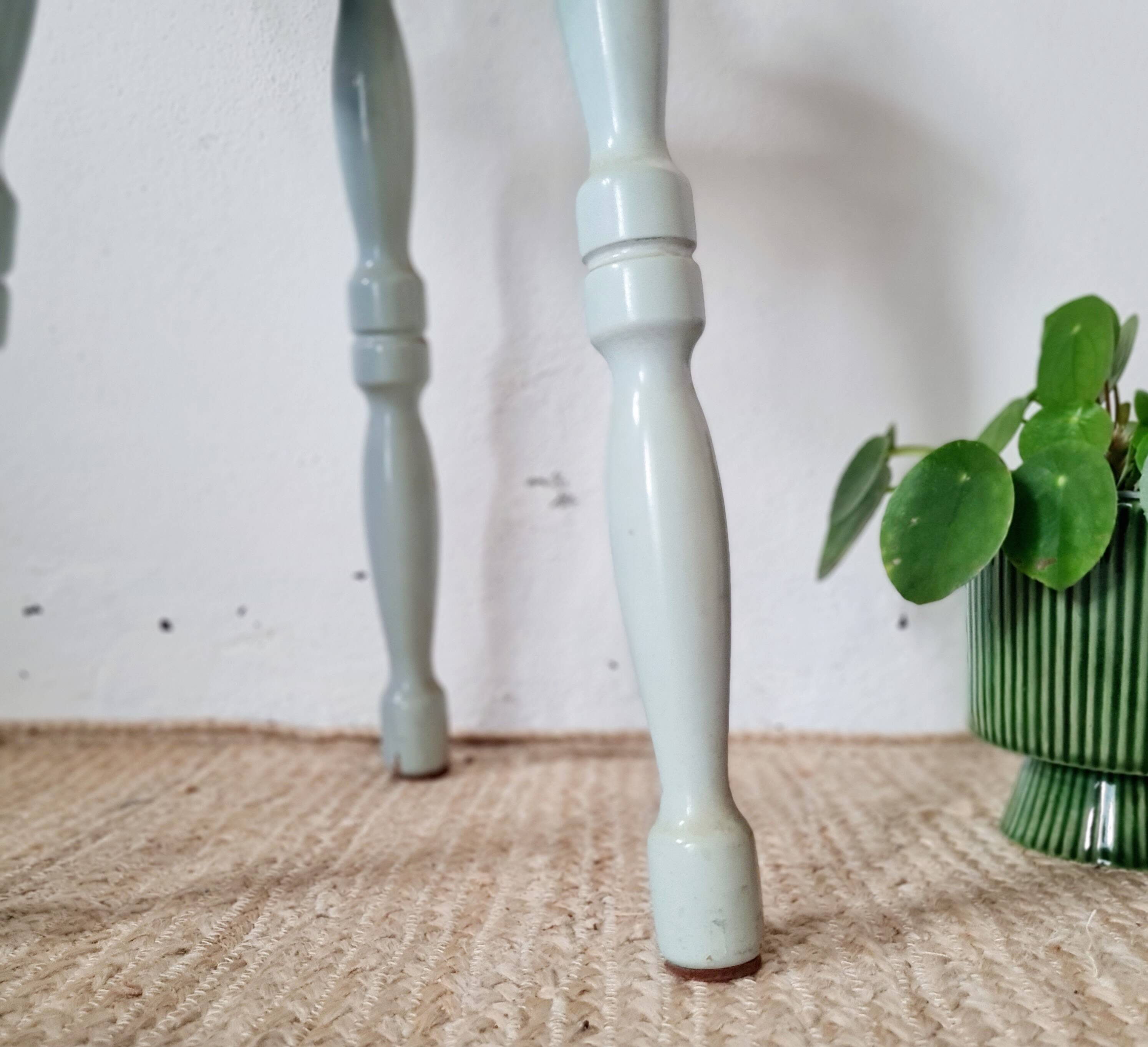 Antique tripod stool made of solid wood in blue.