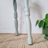 Antique tripod stool made of solid wood in blue.