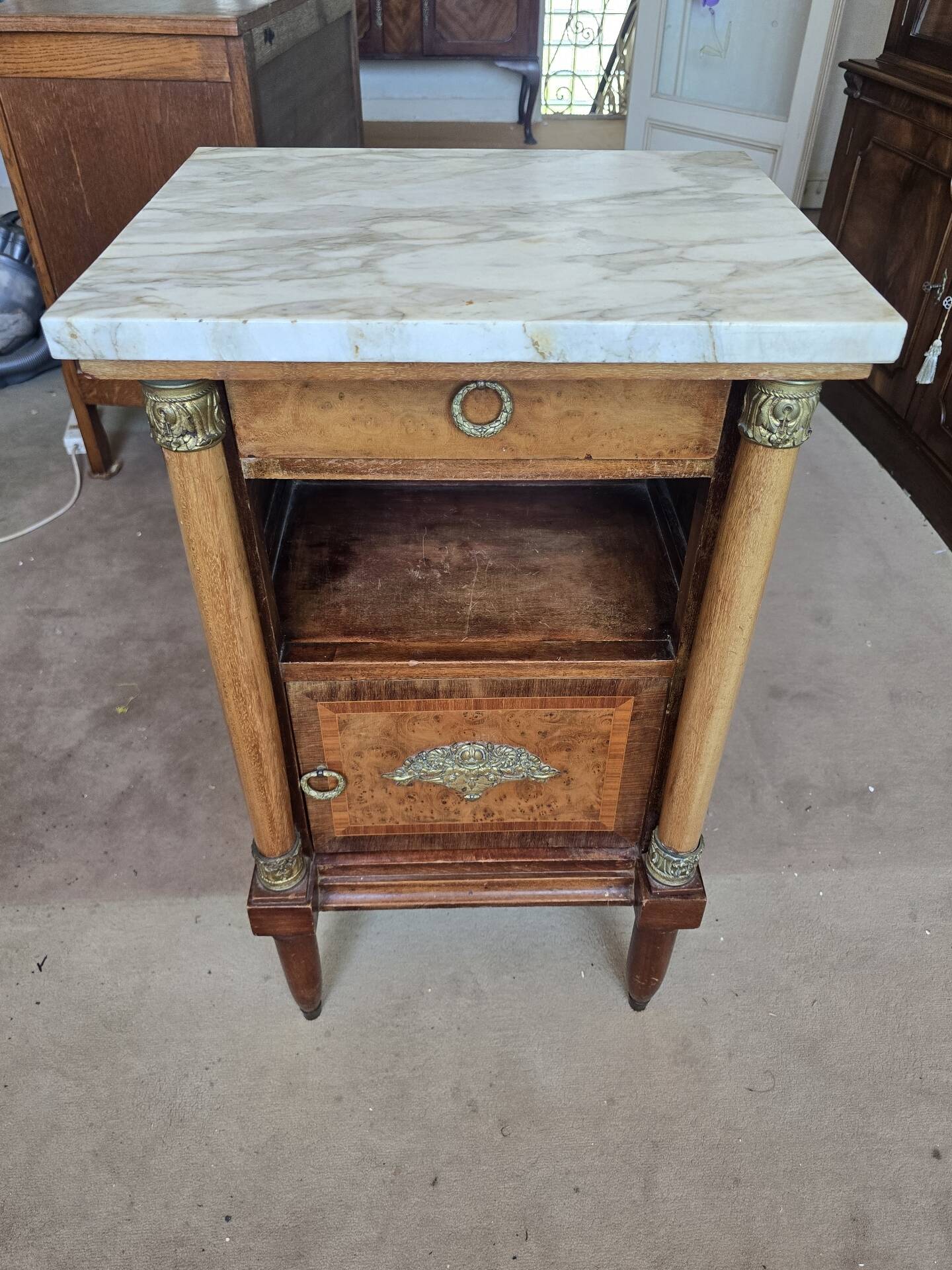 Antique Empire-style bedside table with marble top.