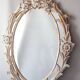Antique oval mirror carved in wood.