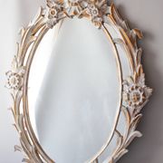 Antique oval mirror carved in wood.
