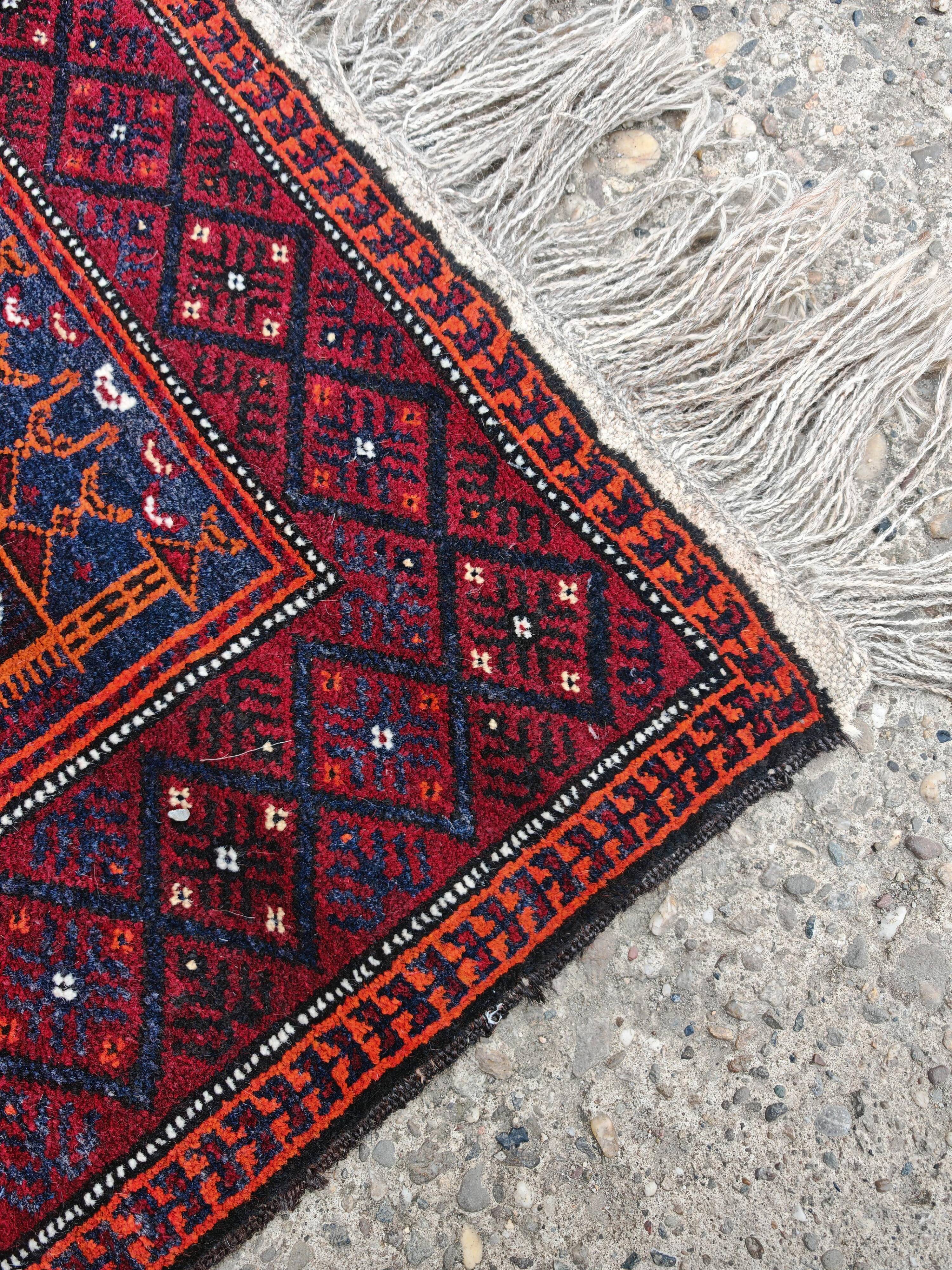 Vintage hand-knotted Persian Baluch prayer rug from the 1940s.