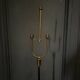 1960 floor lamp on gold metal winged base with black barrel