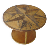 Round coffee table in bamboo, rattan, and wood with an 80s star pattern.
