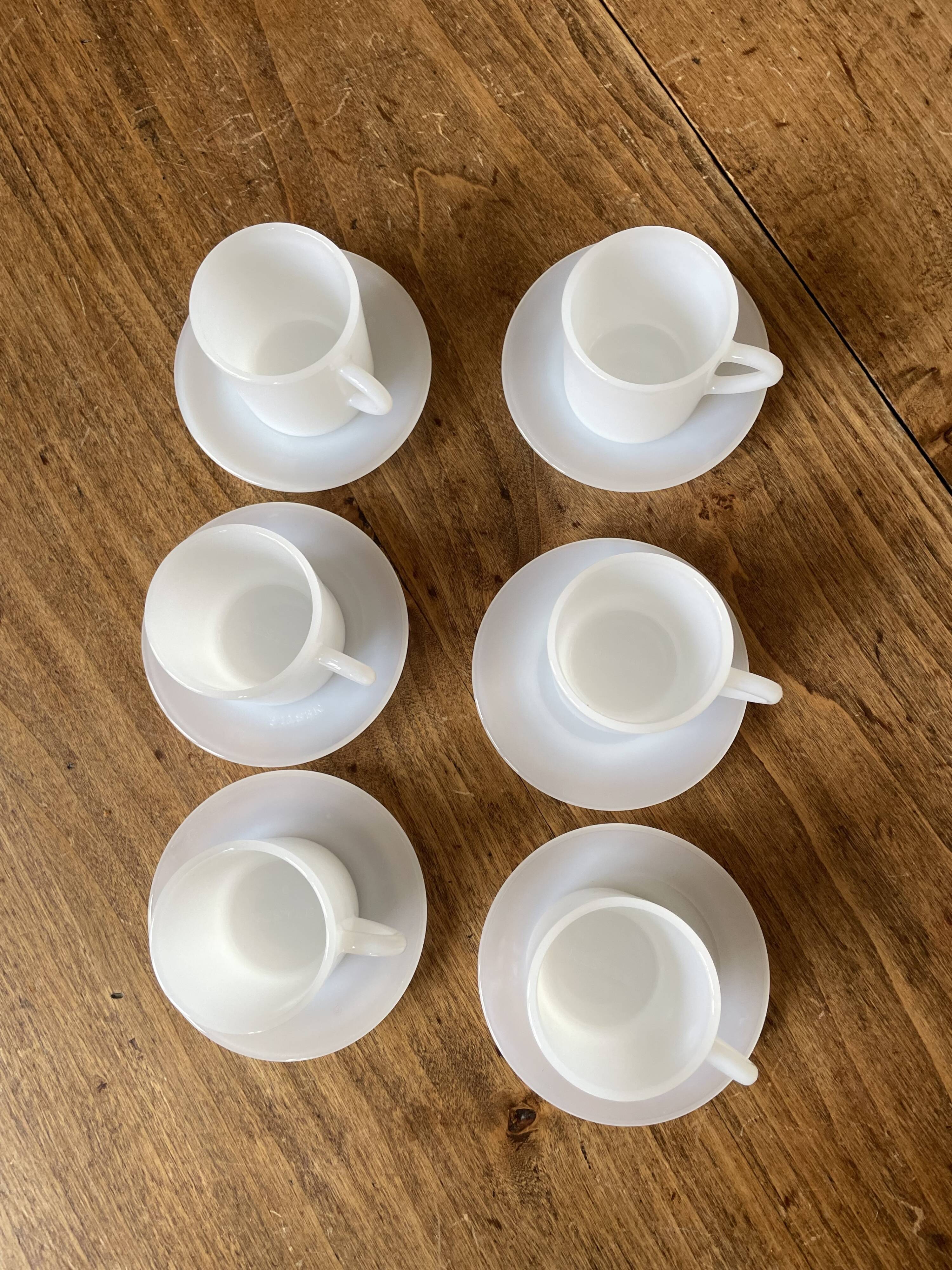 Espresso coffee cup service, Nestlé promotional items, in white glass.