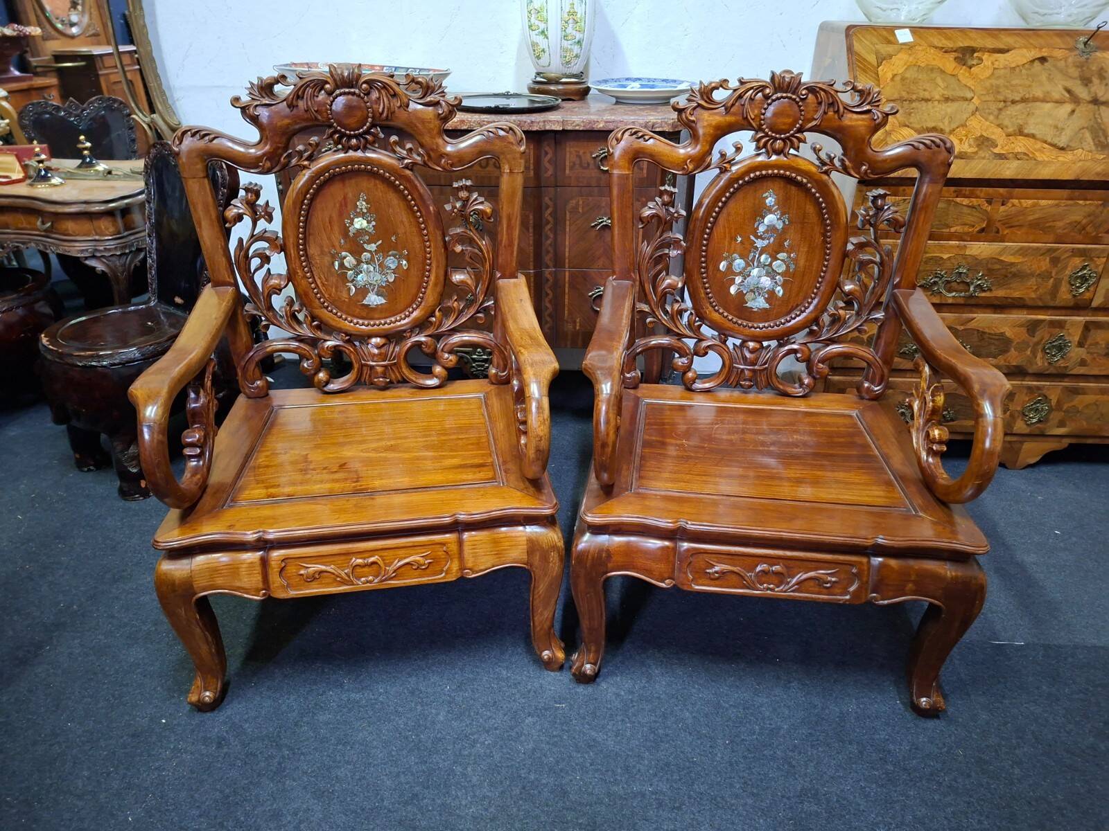 Pair of Asian armchairs in carved wood with mother-of-pearl inlays.