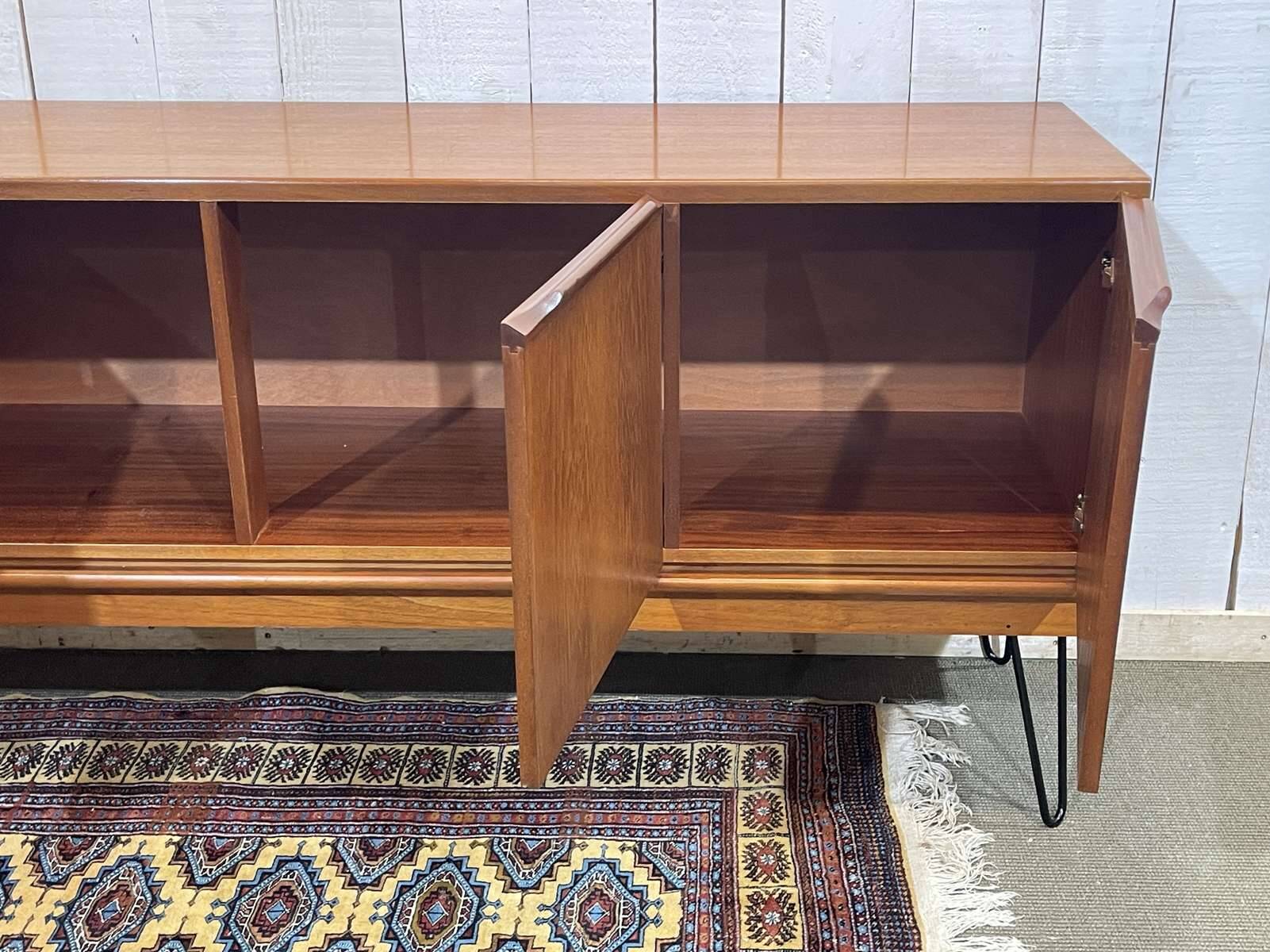 1970s English enfilade in teak with splayed legs.