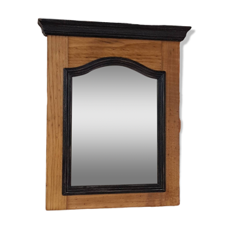 Black mirror and raw natural wood