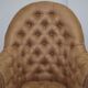 Chesterfield armchair in hardwood, leather, and woven linen.